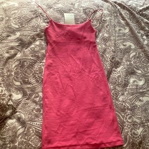 Short pink dress with straight neckline and spaghetti straps.